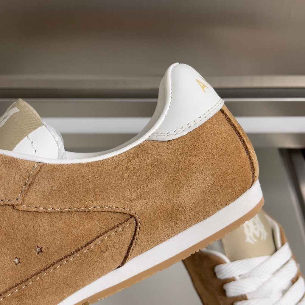 Tan suede sneaker with white heel tab and contrast trim, side close-up