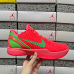 Red low-top sneaker with green swoosh and textured upper, lace-up
