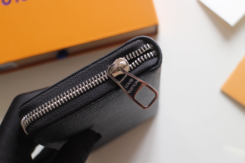 Louis Vuitton small black zip bag with silver zipper pull and front hardware
