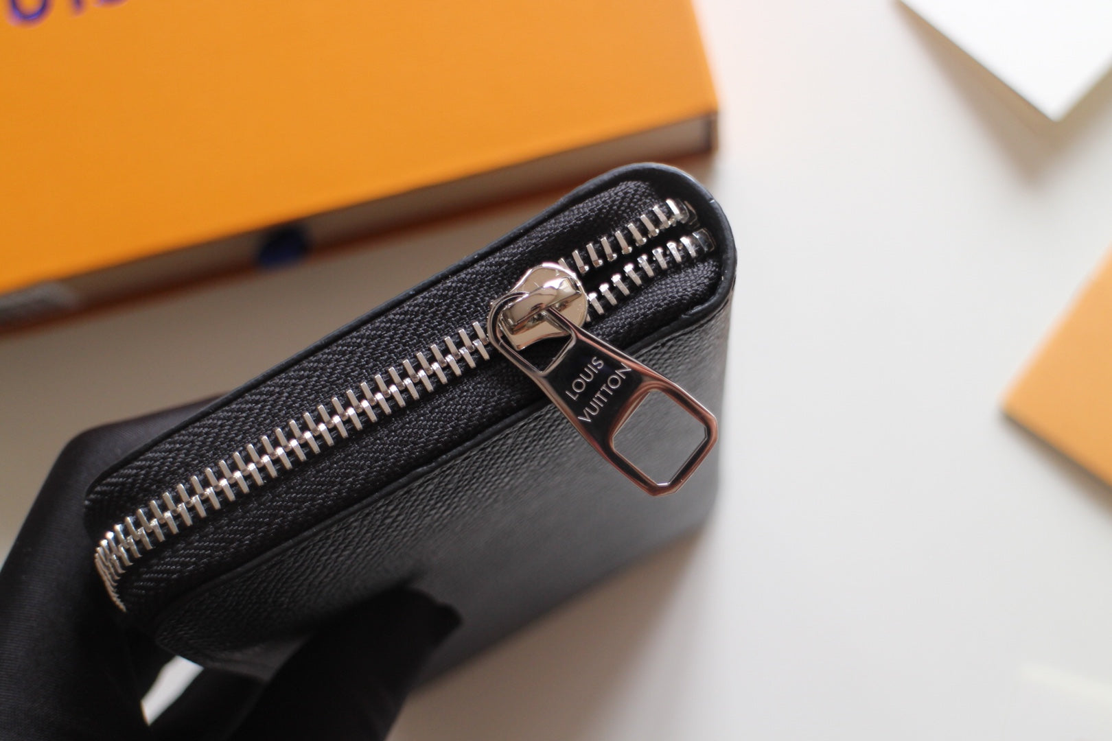 Louis Vuitton small black zip bag with silver zipper pull and front hardware