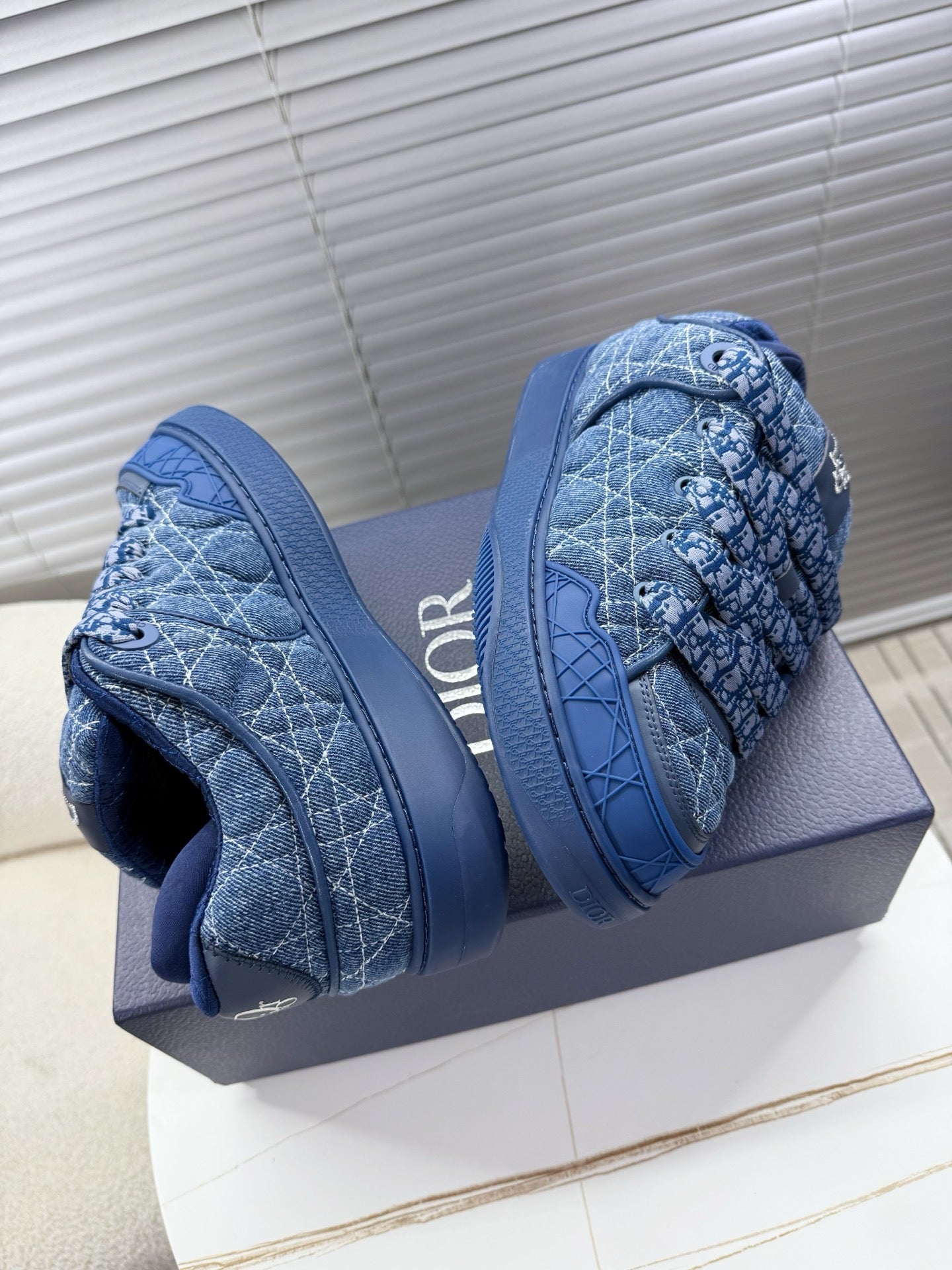 Blue unisex Dior sneakers, toe and side view with quilted logo pattern