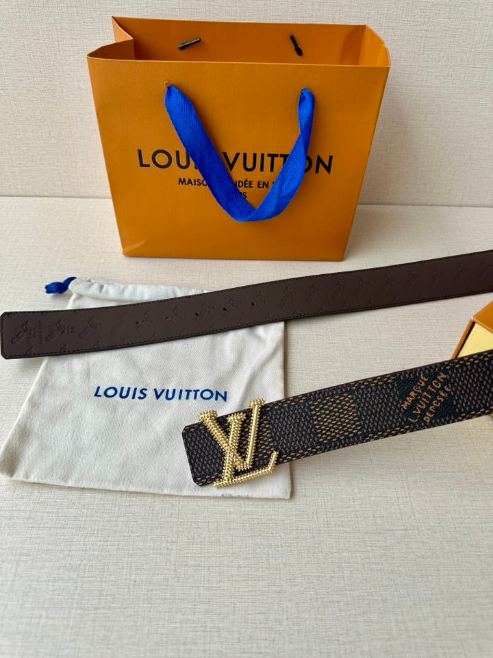 Dark monogram belt with gold V-shaped LV buckle in rhinestones, flat strap.