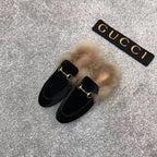 Black velvet loafer slide with beige faux fur lining and gold-tone ring detail
