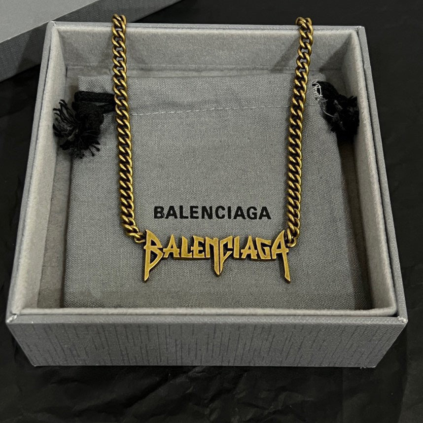 Gold Balenciaga logo necklace in gift box with twisted chain and logo charms