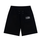 Black Maison Margiela shorts with drawstring and logo graphic on front pocket.