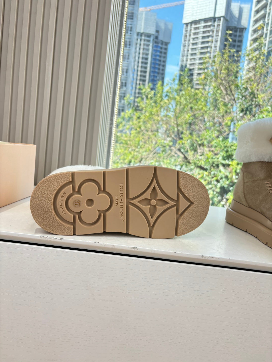 Tan boot outsole with molded monogram flower and geometric LV pattern
