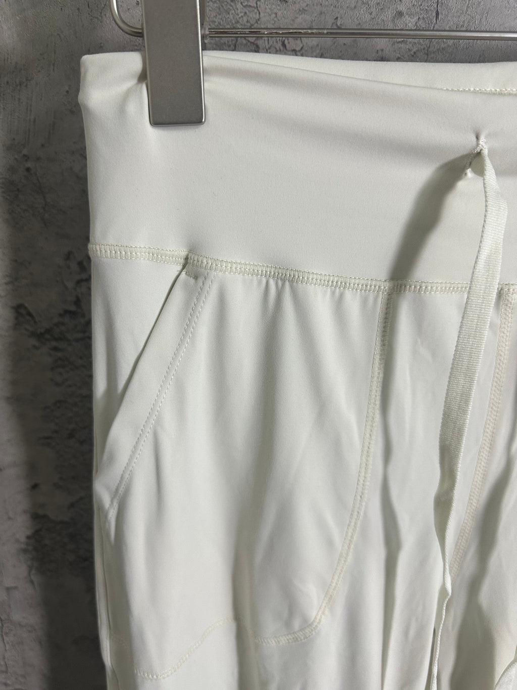 White pants with front patch pocket and stitched panel seams