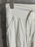 White pants with front patch pocket and stitched panel seams