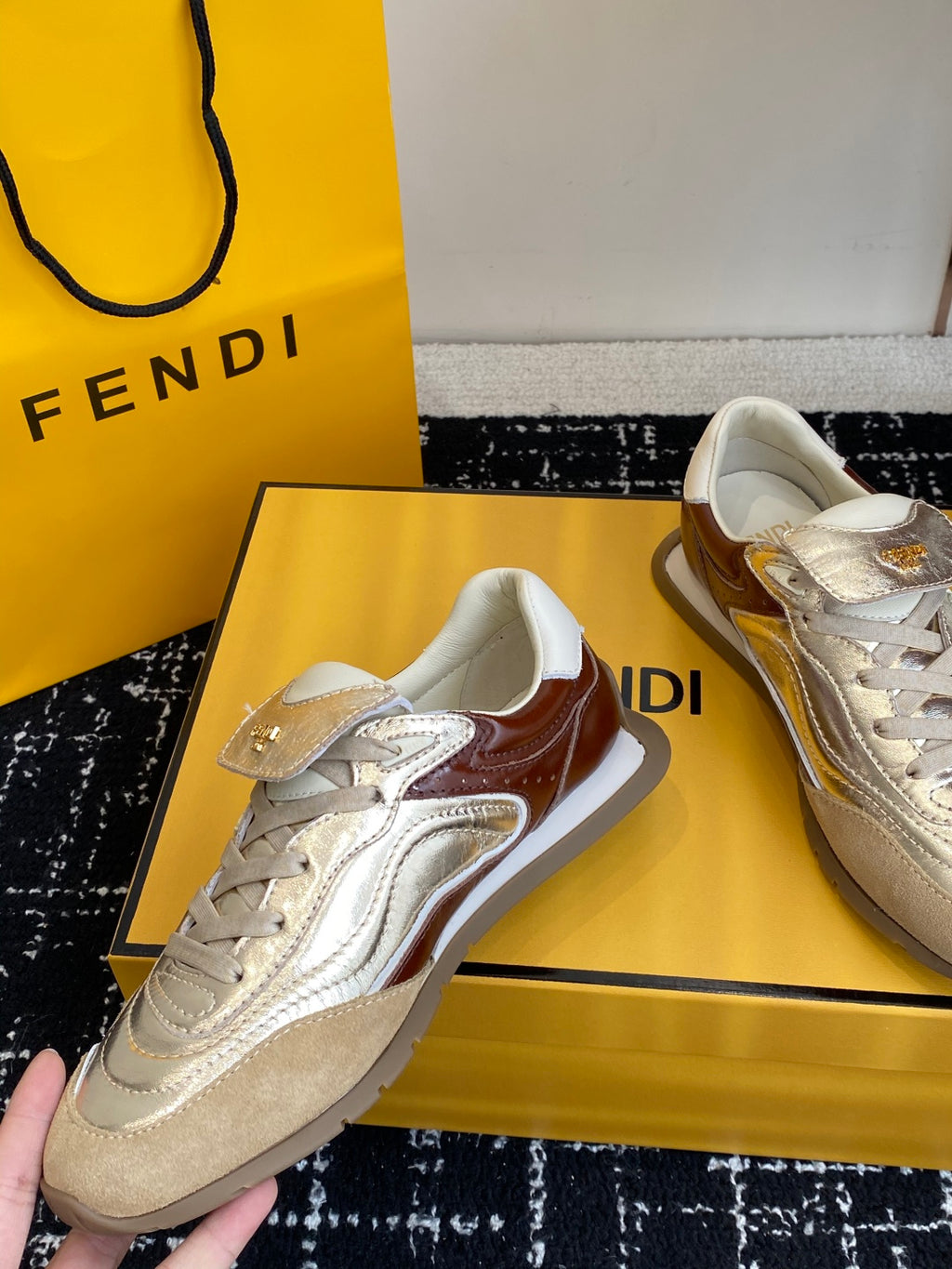 Fendi unisex sneakers in metallic silver and white with brown side trim, on box