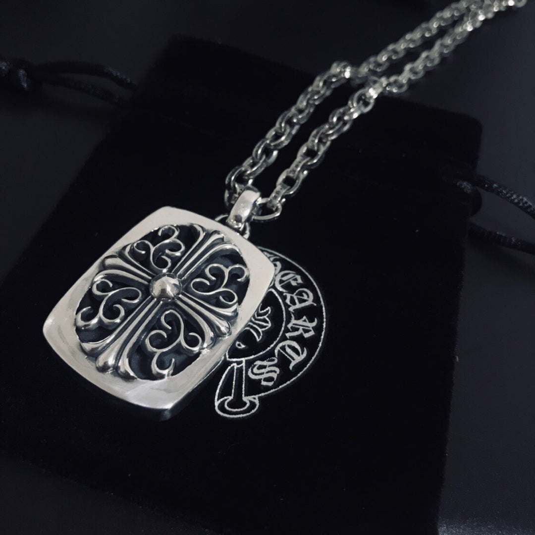 Silver square pendant necklace with filigree scroll design on linked chain