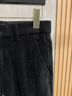 Black trousers with pleated waistband and front belt loops