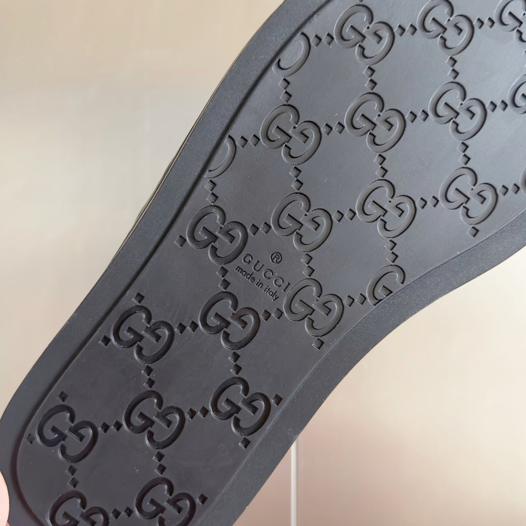 Gucci dark rubber sandal sole with embossed G logo pattern and size text