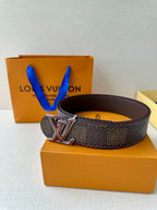 Belt with dark monogram strap, brown underside, and LV emblem buckle