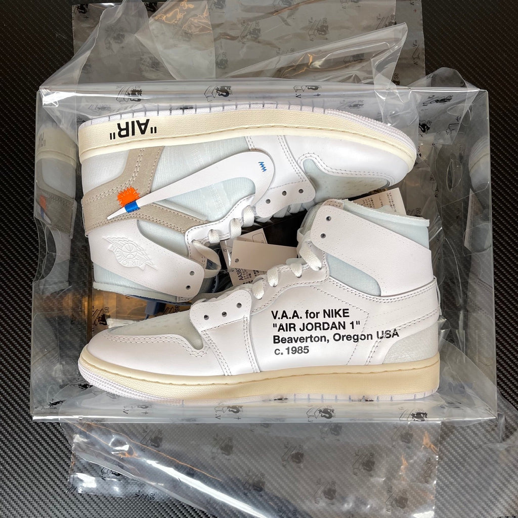 Packaged pair of high-top sneakers in clear box, white uppers with light blue and gray details