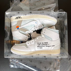 Packaged pair of high-top sneakers in clear box, white uppers with light blue and gray details