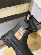Black leather Chelsea boots with check-panel side gore and chunky tread sole