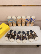 Fendi slide sandals display with blue monogram and dark patterned slides