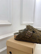 Olive green monogram slide sandal with buckle strap and plush shearling collar