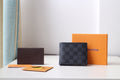 Dark checkered Louis Vuitton small wallet with front logo panel