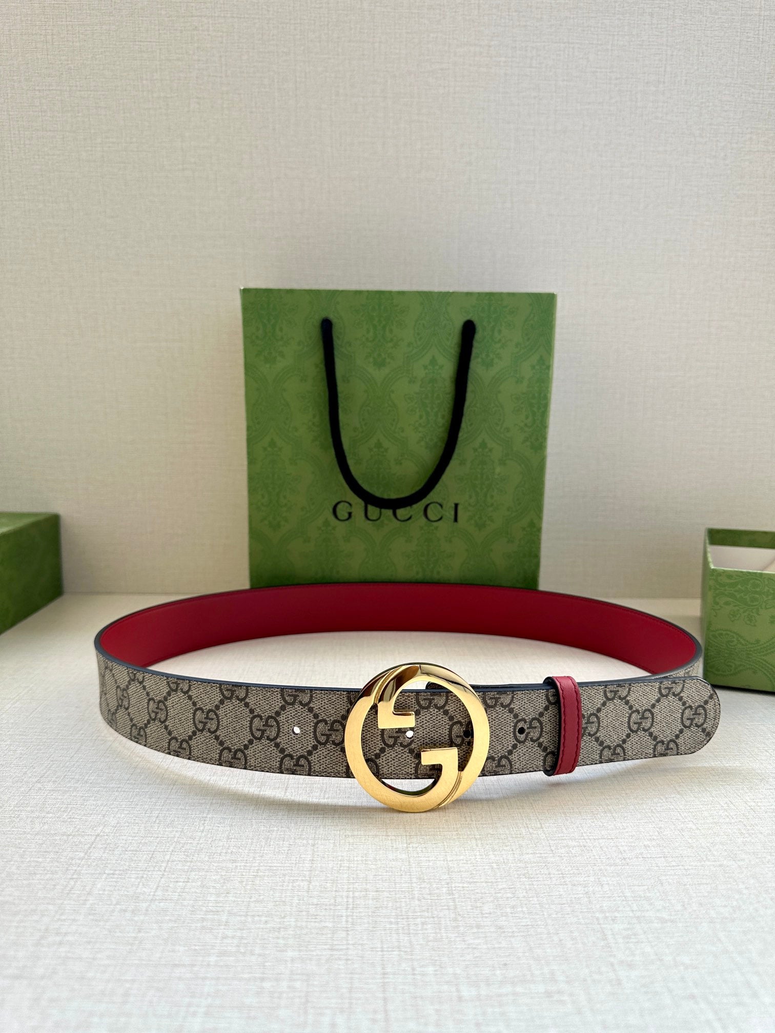 Gucci GG canvas belt with gold-tone G buckle and red leather backing