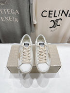 Pair of white Golden Goose sneakers with lace-up design, front view
