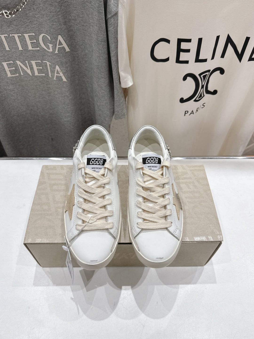 Pair of white Golden Goose sneakers with lace-up design, front view