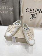 White lace-up Golden Goose sneakers, angled side view on box