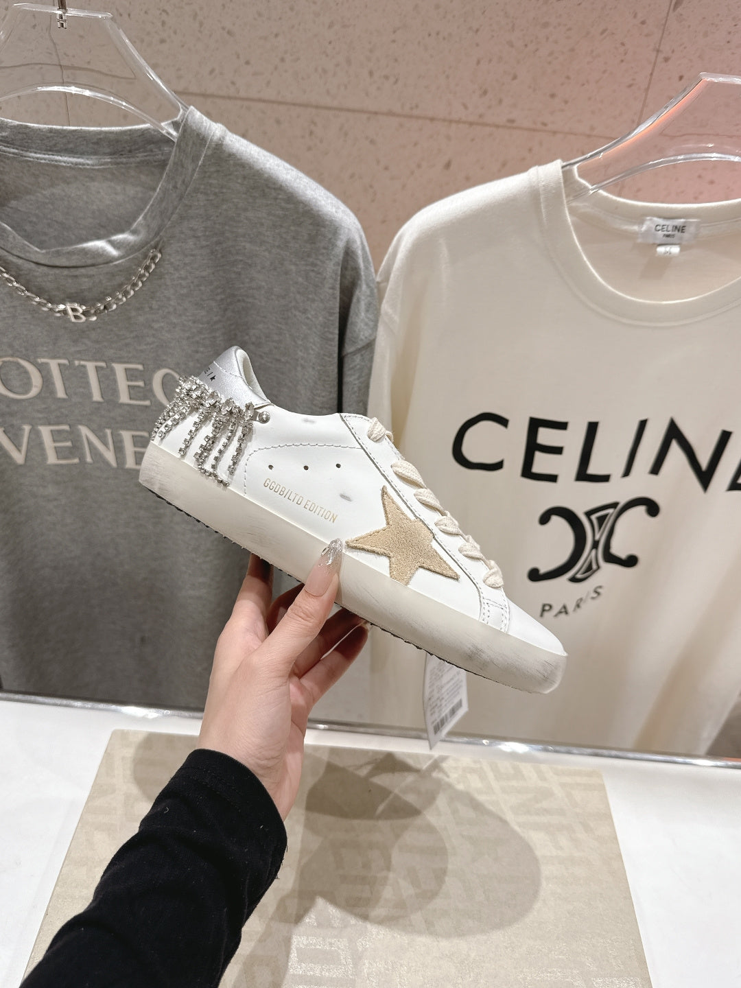 White Golden Goose low-top sneakers with star-shaped side patch, held shoe