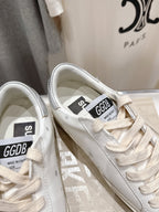 White Golden Goose sneakers close-up of tongue labels and lace-up details