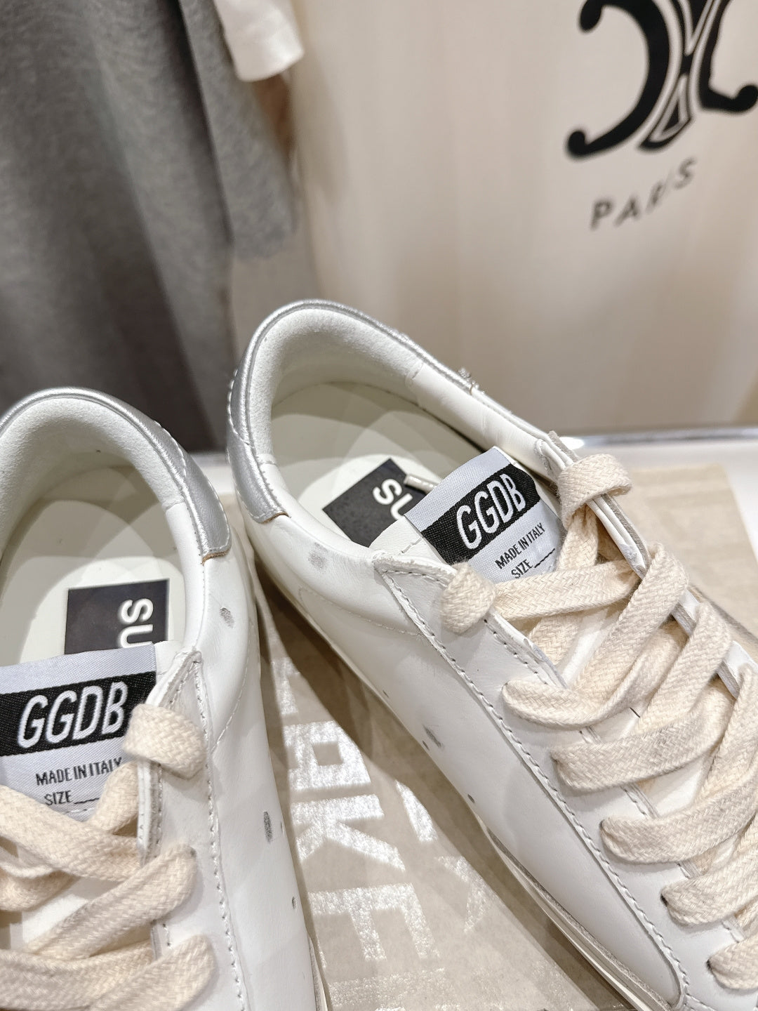 White Golden Goose sneakers close-up of tongue labels and lace-up details