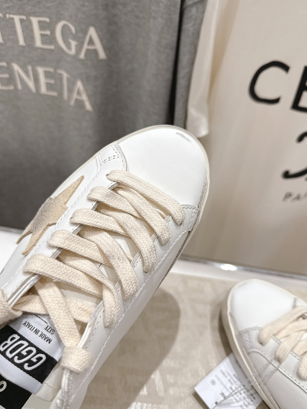 White Golden Goose low-top sneaker close-up with lace-up and perforations