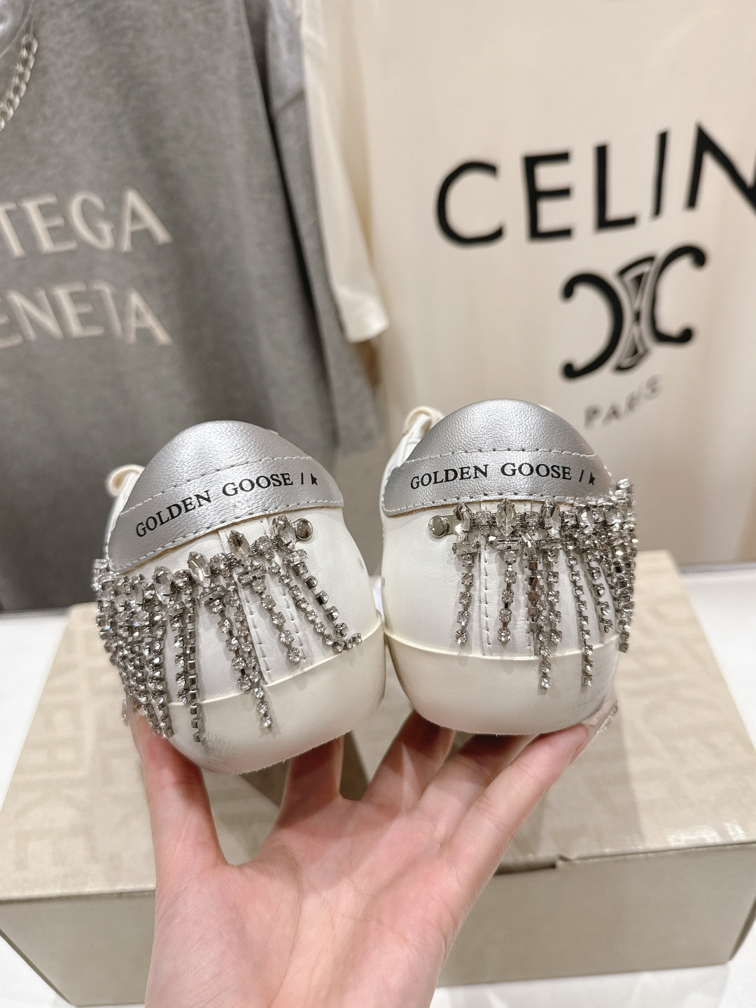 Pair of white Golden Goose slip-on shoes with silver fringe strap detail