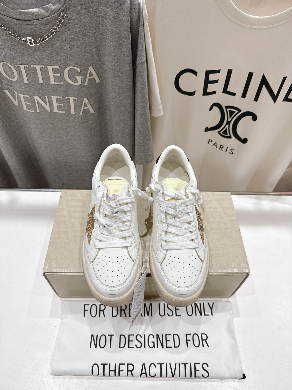 White lace-up sneakers with perforated toe and cushioned sole, front view