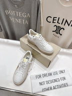 Pair of white lace-up sneakers with perforated details and matching laces