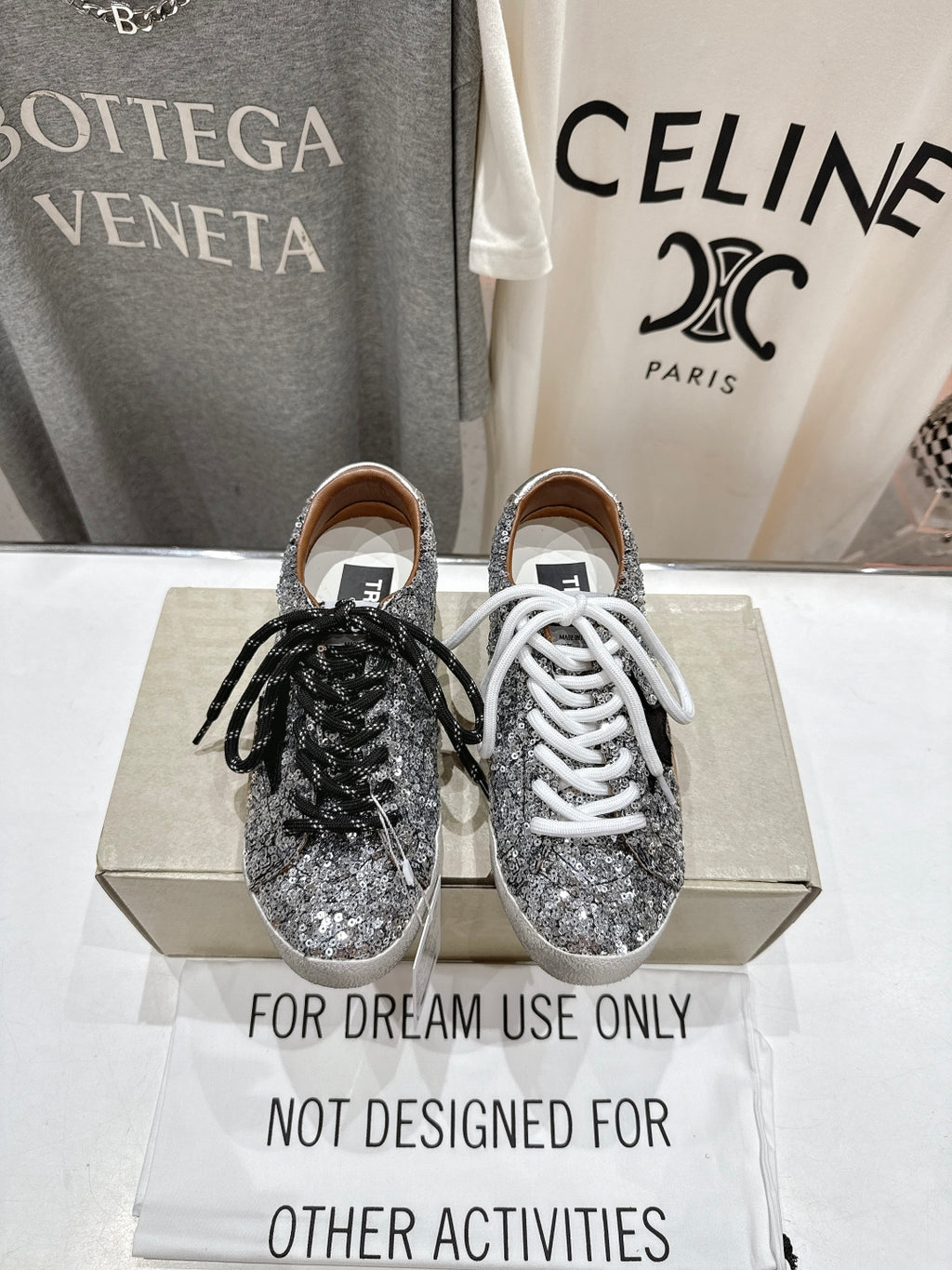 Pair of silver sequin sneakers, one with black laces and one with white laces