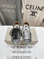 Pair of silver sequin sneakers, one with black laces and one with white laces