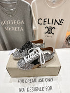 Silver sequin low-top sneakers on box, black and white laces