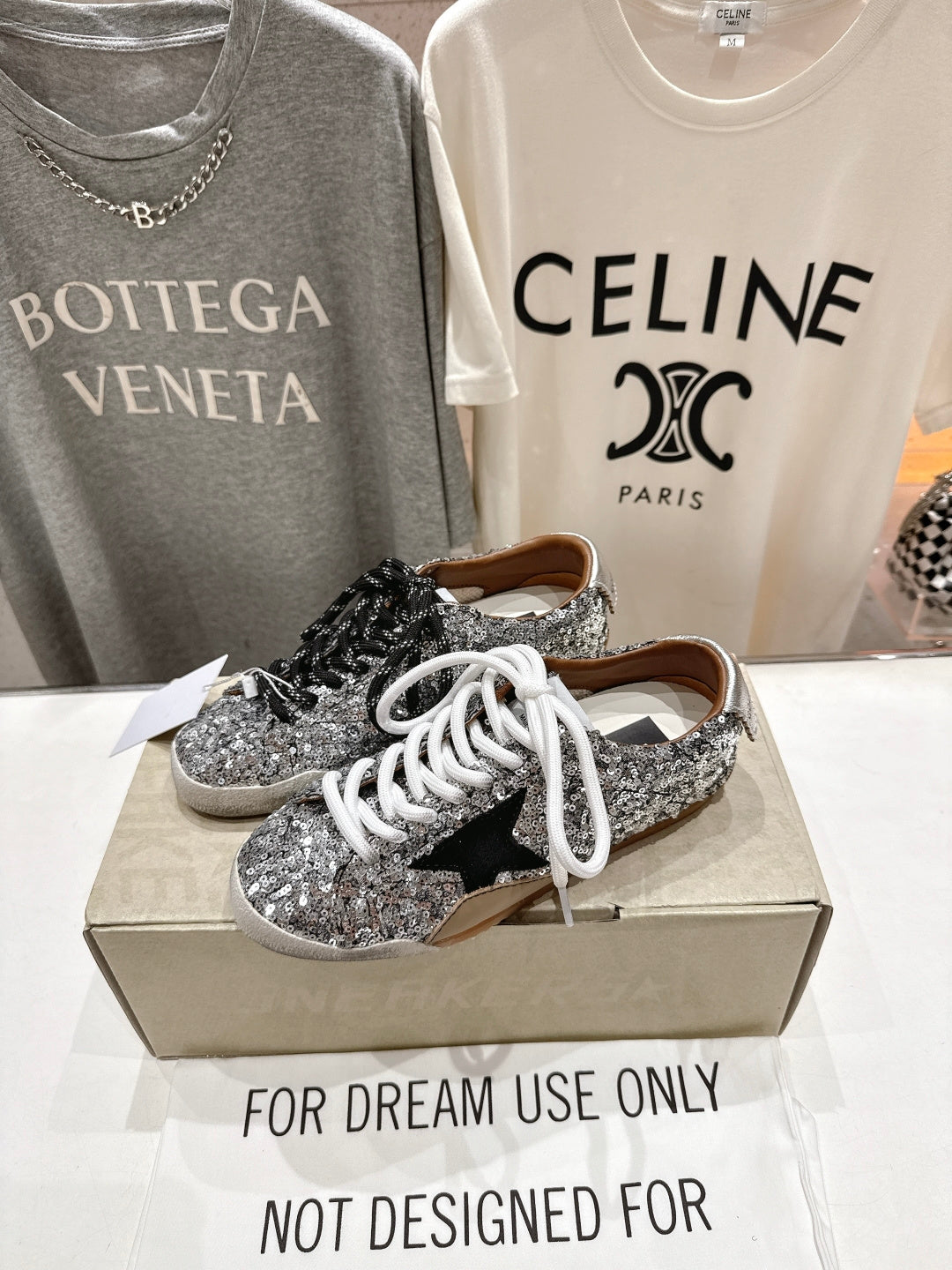Silver sequin low-top sneakers on box, black and white laces