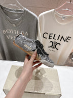 Held silver and black sequin sneaker with black lace, side profile