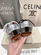 Back view of Golden Goose sneakers: silver sequin heels, black and white laces