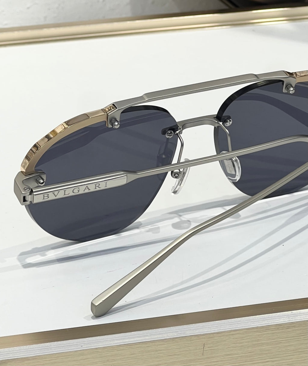 Bvlgari sunglasses close-up with dark lenses, gold trim, and Bvlgari logo