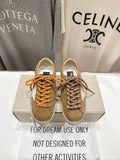 Golden Goose low-top sneakers in tan with white star patch and orange laces