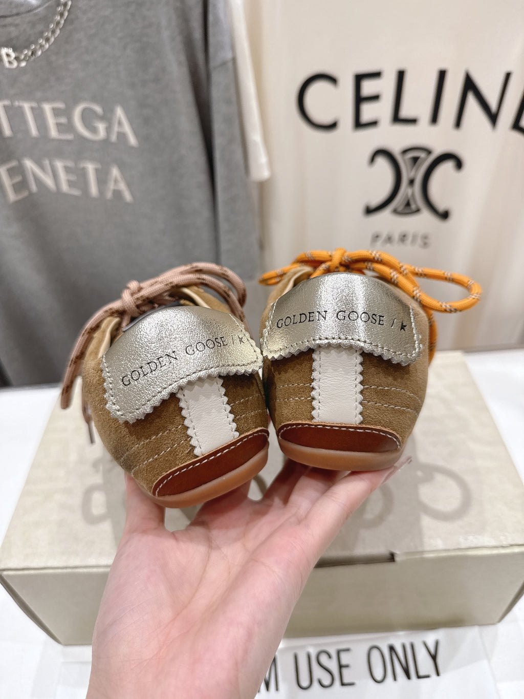 Golden Goose sneakers from back in tan with orange and brown laces