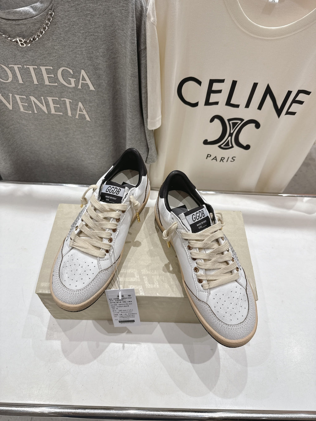 Golden Goose sneakers with white uppers, cream laces, black collar, side perforations