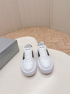 Pair of Prada unisex white sneakers with black side panel and padded collar