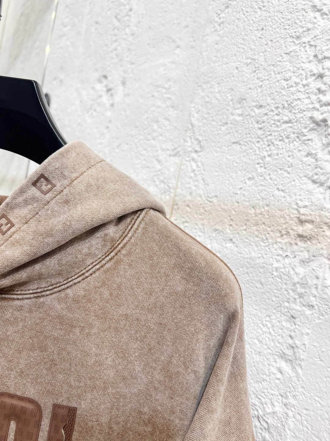 Beige FENDI hoodie shoulder seam detail and hood with stitched label tab.
