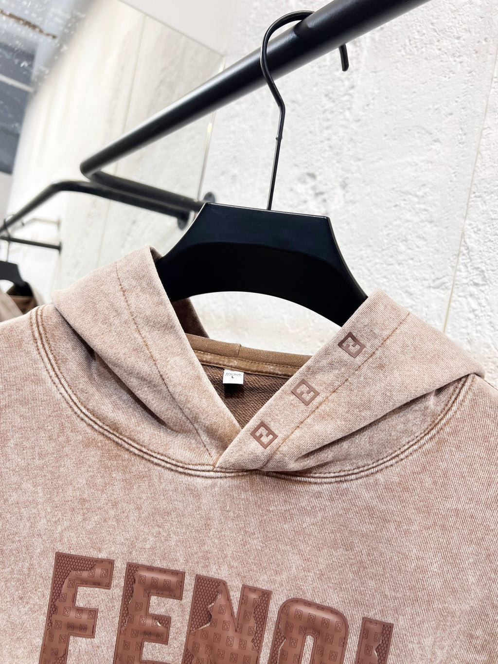 Beige FENDI hoodie neckline and hood, with front logo print detail.