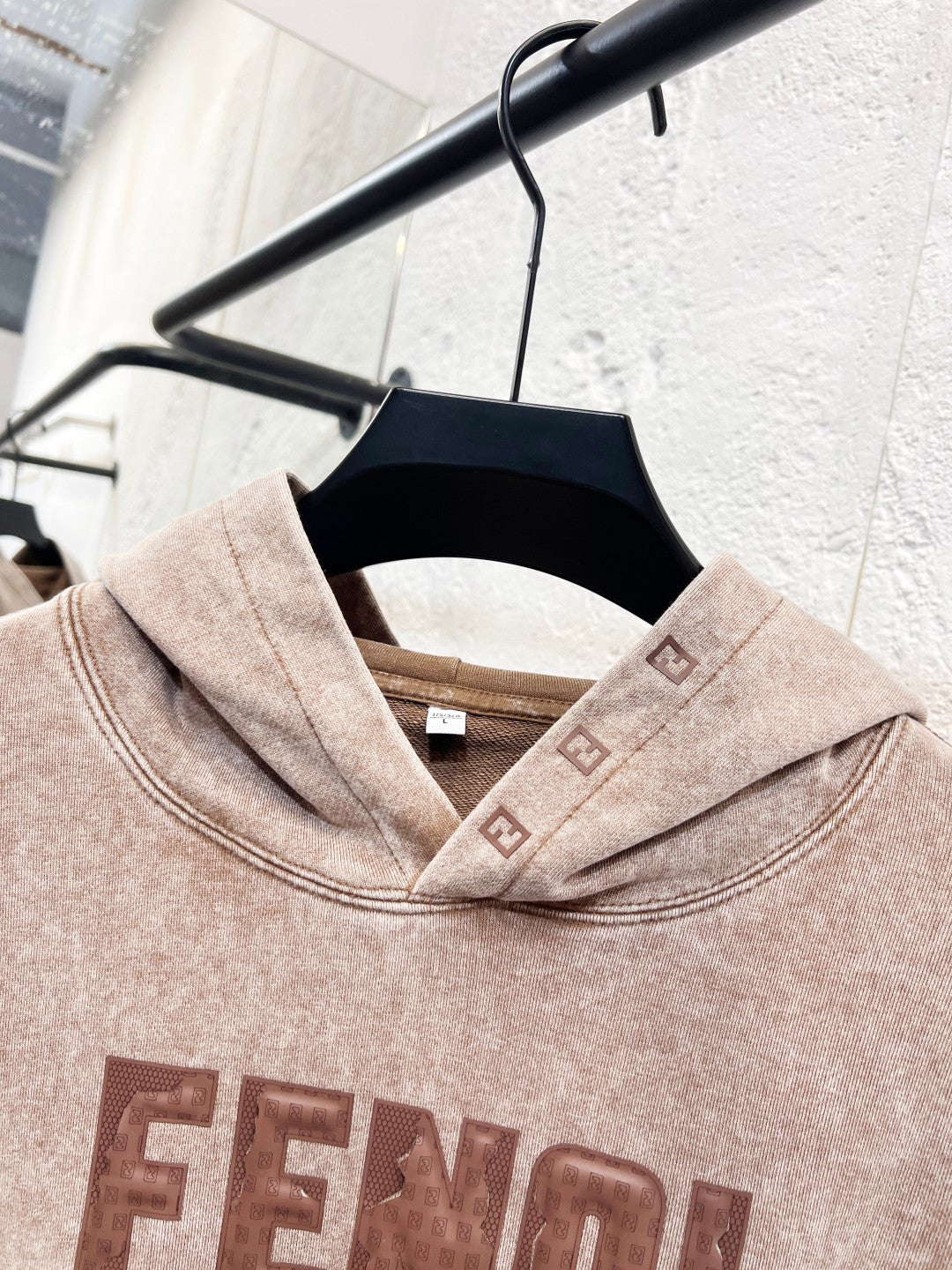 Beige FENDI hoodie neckline and hood, with front logo print detail.