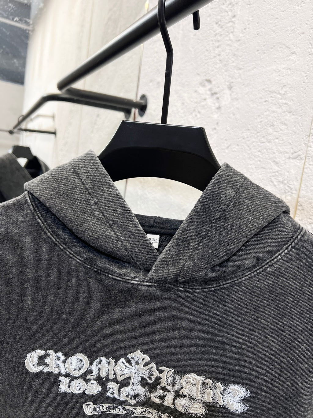 Heather gray hoodie sweatshirt with large white graphic print across the chest