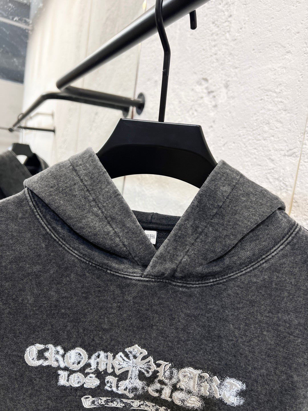 Heather gray hoodie sweatshirt with large white graphic print across the chest